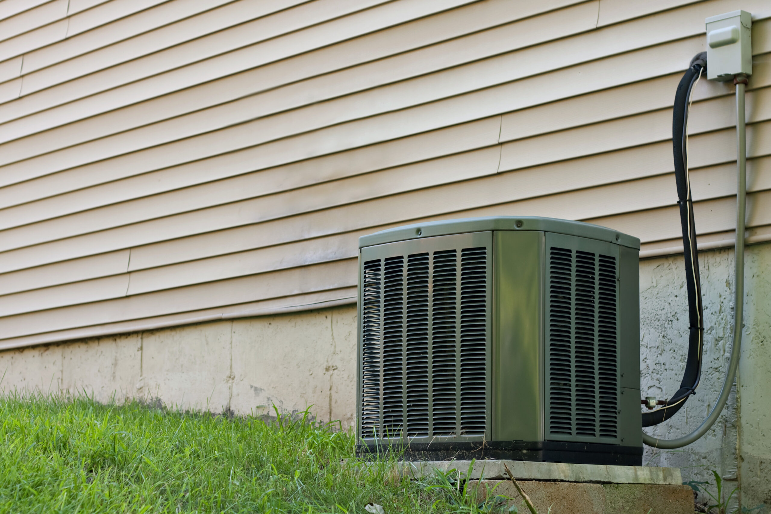 a-residential-central-air-conditioning-unit-sitting-outside-a-home-used-for-regulating-SBI-301041123-1-scaled.jpg